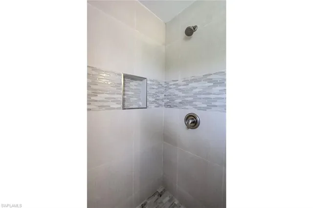 a bathroom with a granite countertop shower