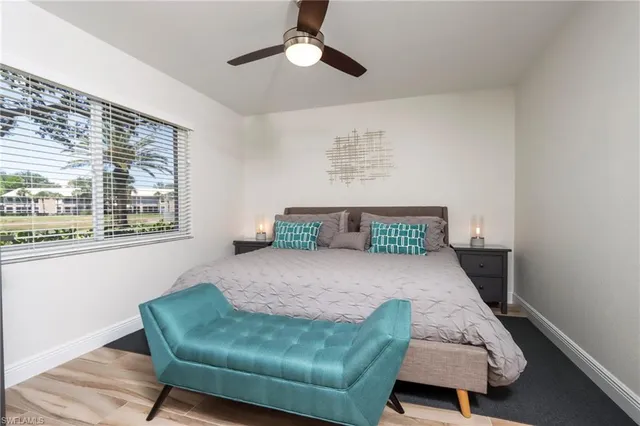 a bedroom with a bed window and couch