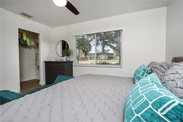 a bed room with a bed and a wall painting