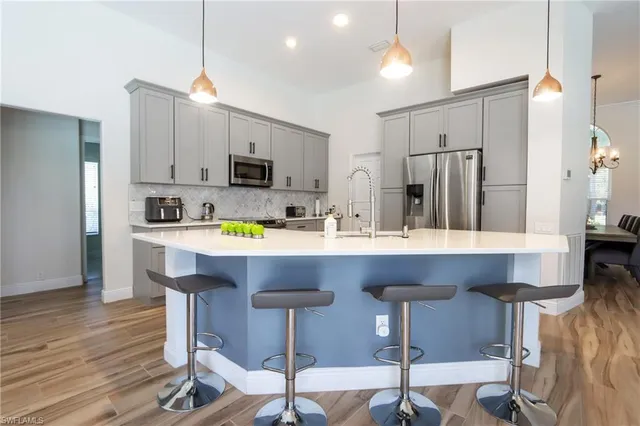 a kitchen with a sink cabinets and dining table