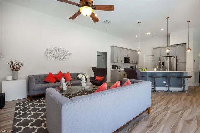 a living room with furniture and a wooden floor