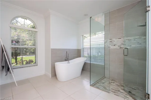 a bathroom with a bathtub and shower