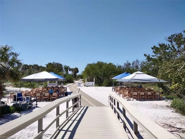 a view of a patio with a table and chairs under an umbrella