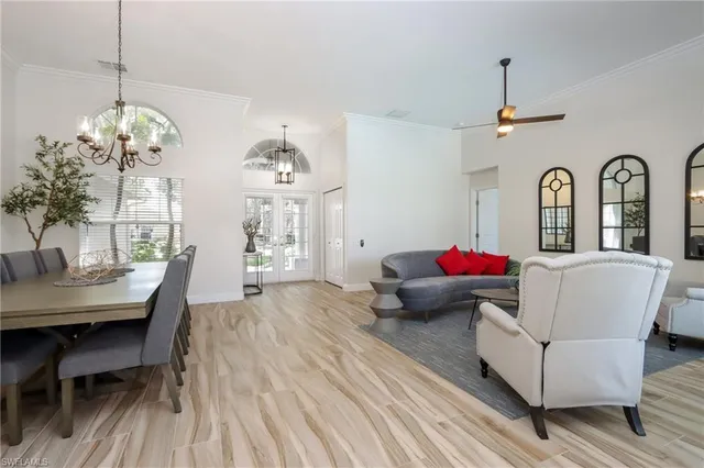 a living room with furniture chandelier and a chandelier