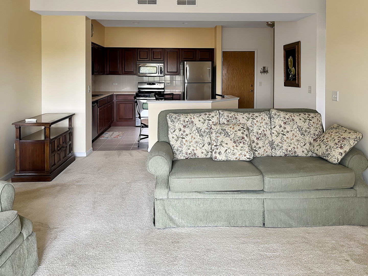 3451 North Carriageway Drive, Unit 503 Arlington Heights, IL 60004 - Photo 11 of 22 a living room with a couch and a flat screen tv