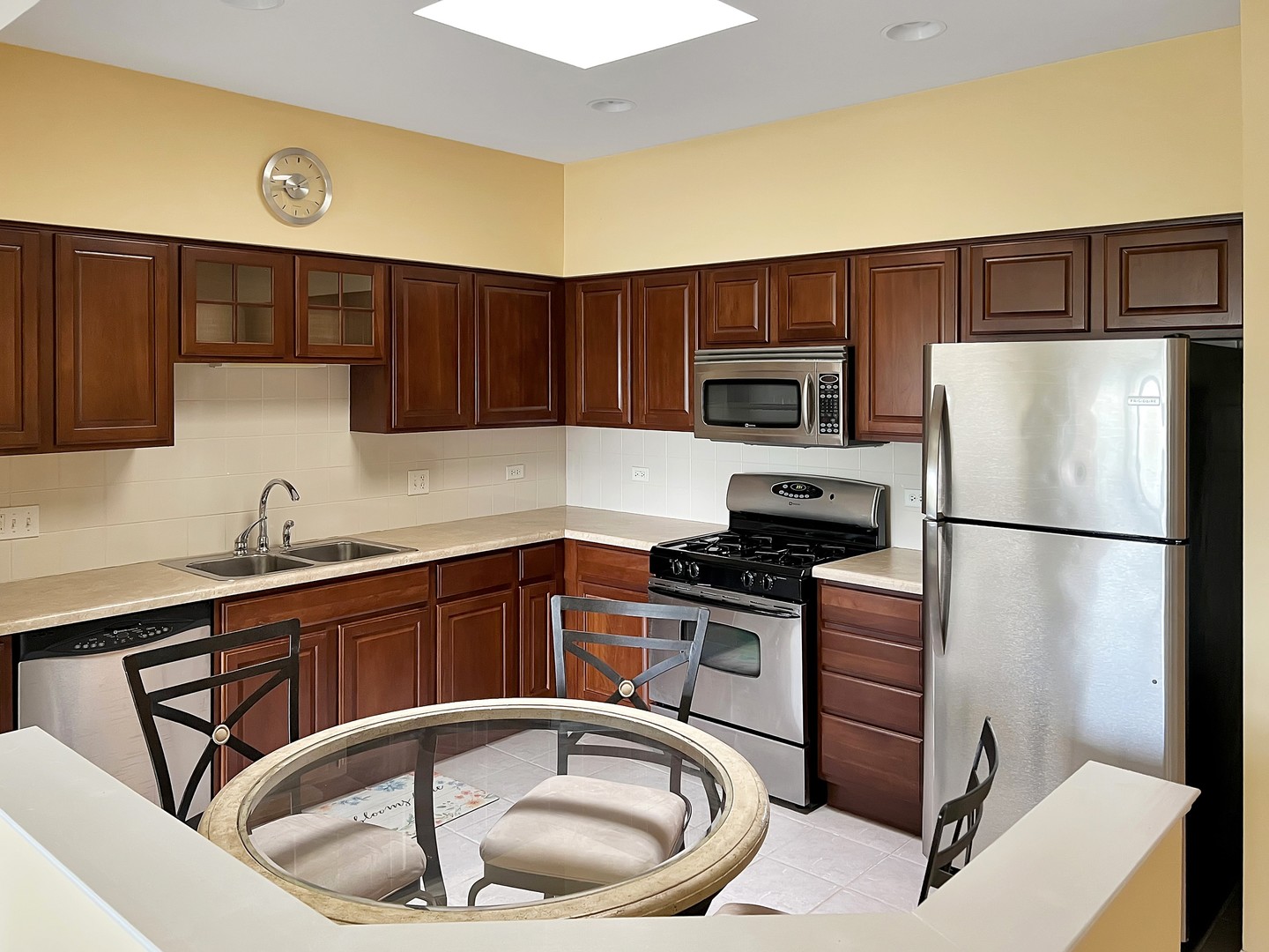 3451 North Carriageway Drive, Unit 503 Arlington Heights, IL 60004 - Photo 4 of 22 a kitchen with a refrigerator sink and microwave