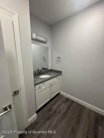 a room with a sink a stove and a mirror