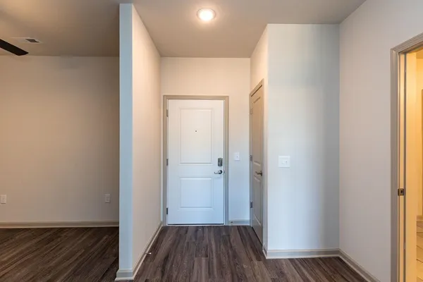 a view of a hallway with wooden floor