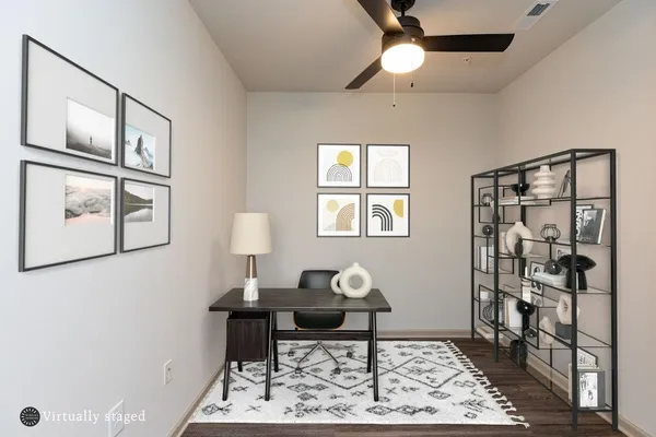 a living room with furniture a rug and a window