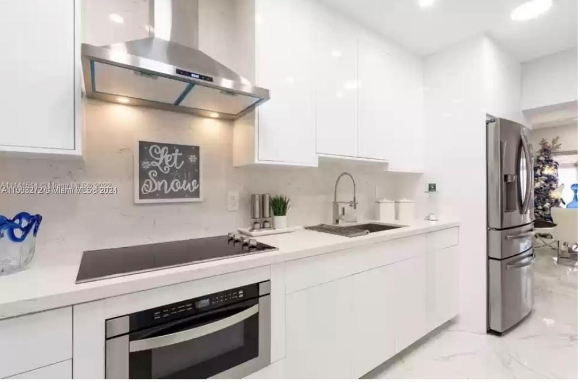 3172 Southwest 2nd Street, Unit 3172 Miami, FL 33135 - Photo 12 of 15 a kitchen with stainless steel appliances a sink and a refrigerator