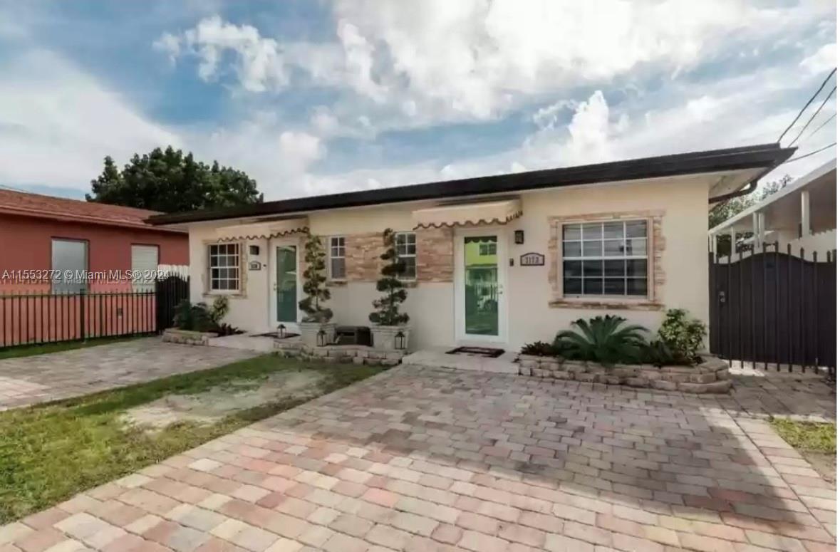 3172 Southwest 2nd Street, Unit 3172 Miami, FL 33135 - Photo 2 of 15 a front view of a house with garden