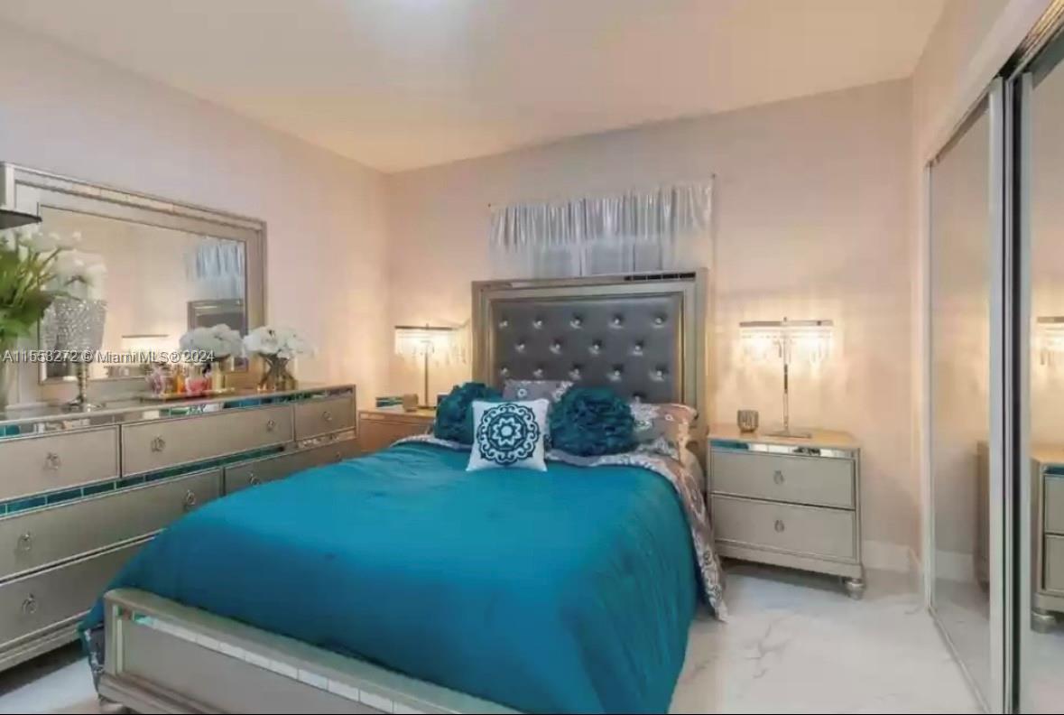 3172 Southwest 2nd Street, Unit 3172 Miami, FL 33135 - Photo 7 of 15 a bed room with a bed and a chair