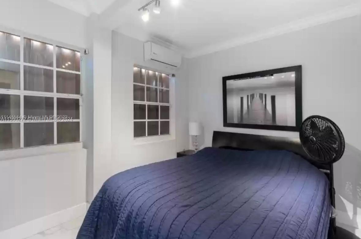 3172 Southwest 2nd Street, Unit 3172 Miami, FL 33135 - Photo 8 of 15 a bedroom with a bed and a window