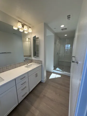 a bathroom with a double vanity sink and a mirror