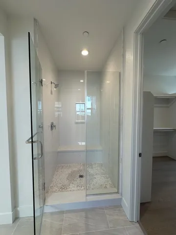 a bathroom with a glass shower door