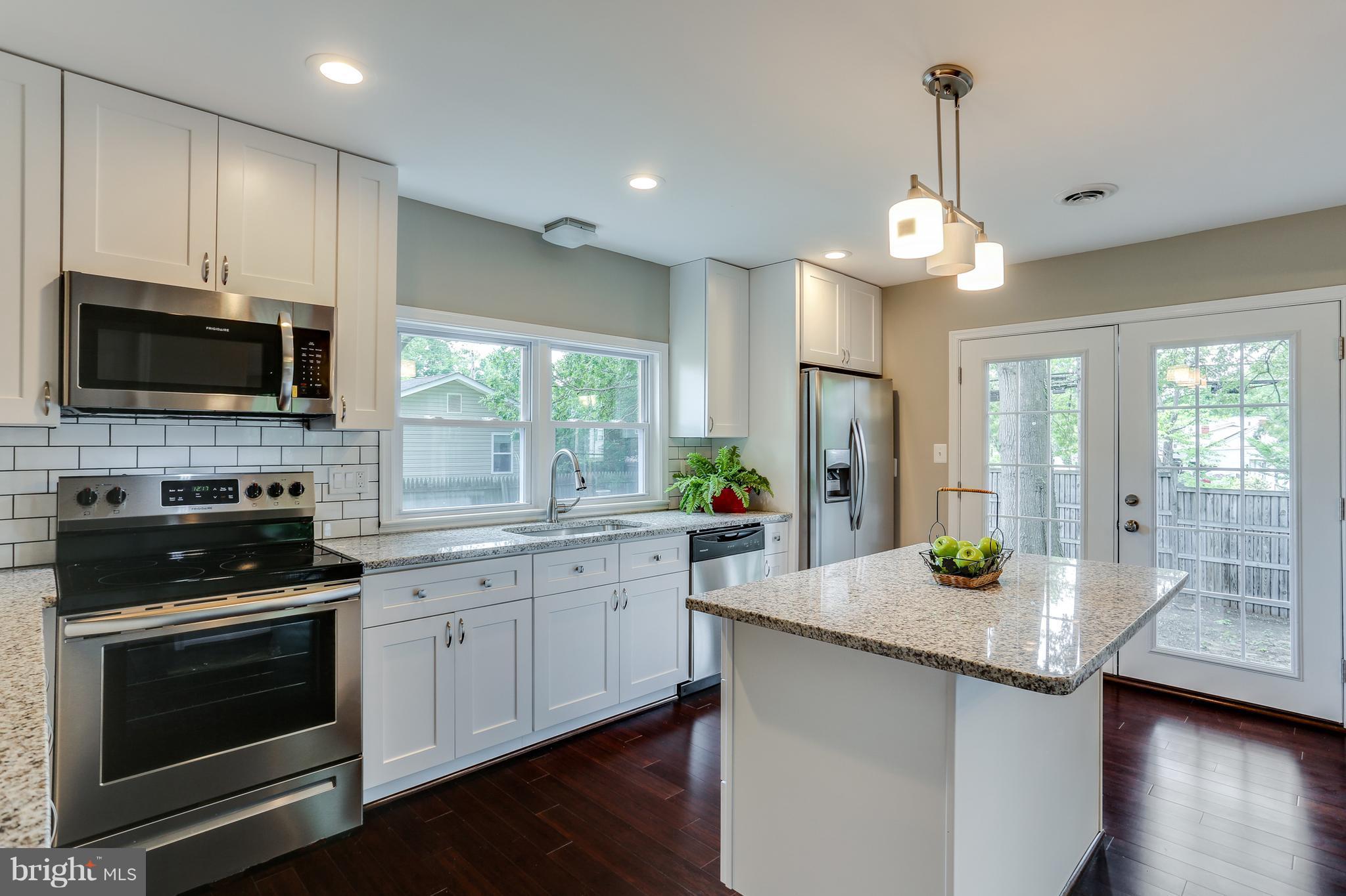1700 Quantico Road Edgewater, MD 21037 - Photo 9 of 25 a kitchen with granite countertop stainless steel appliances a stove sink and microwave
