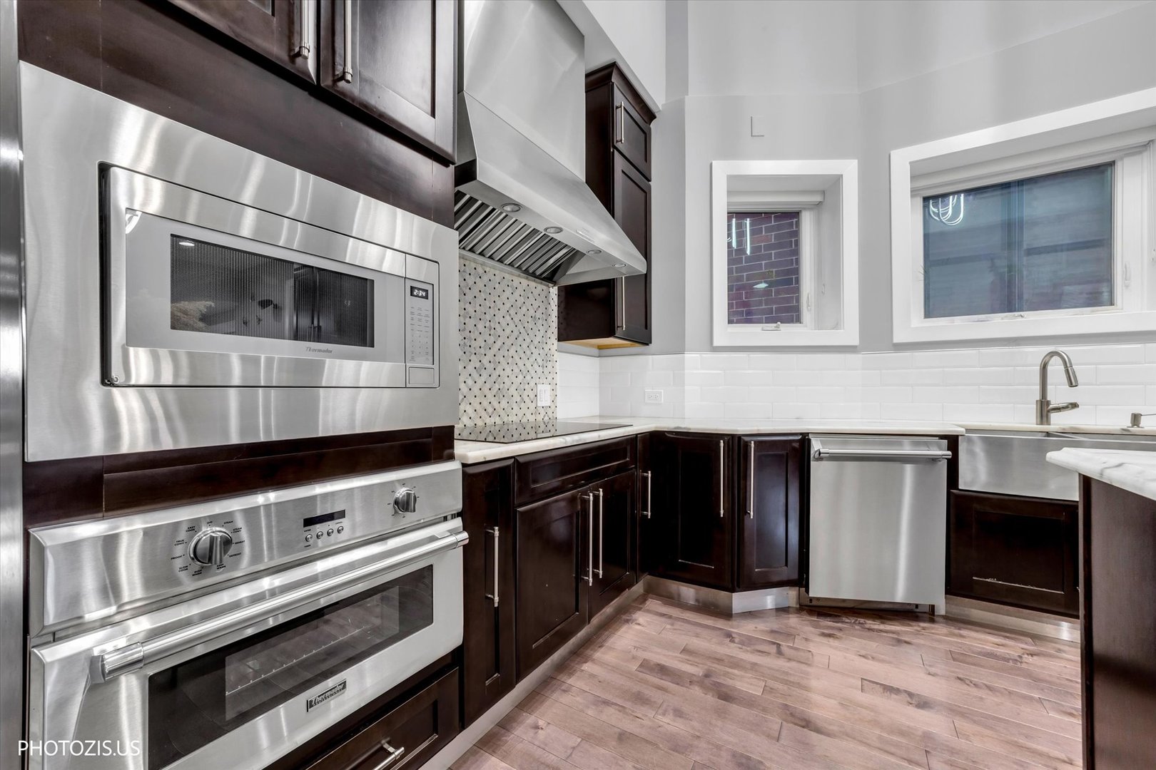 461 West Melrose Street Chicago, IL 60657 - Photo 17 of 83 a kitchen with stainless steel appliances and cabinets