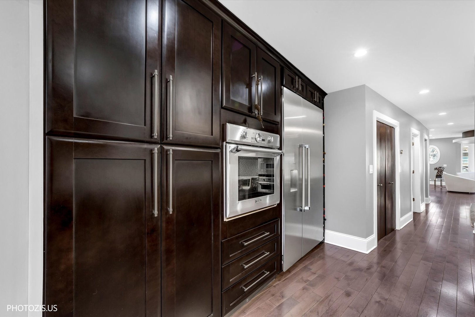 461 West Melrose Street Chicago, IL 60657 - Photo 18 of 83 a kitchen with stainless steel appliances kitchen island granite countertop a refrigerator a stove and a sink
