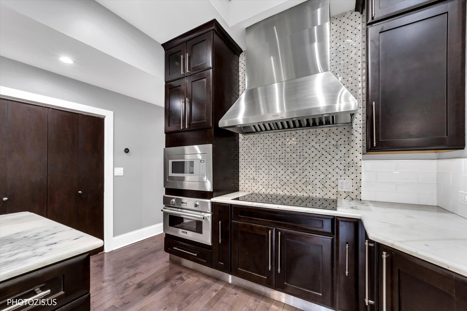 461 West Melrose Street Chicago, IL 60657 - Photo 20 of 83 a kitchen with granite countertop stainless steel appliances and wooden cabinets