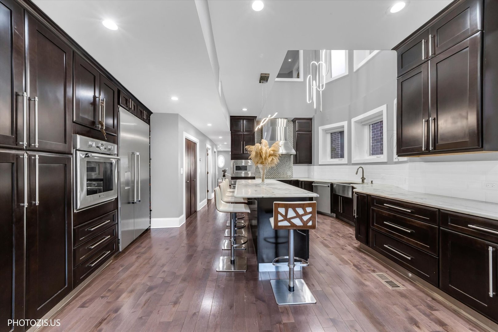 461 West Melrose Street Chicago, IL 60657 - Photo 21 of 83 a kitchen with stainless steel appliances granite countertop a stove refrigerator and wooden floor