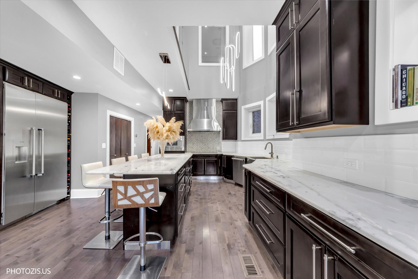 461 West Melrose Street Chicago, IL 60657 - Photo 24 of 83 a kitchen with stainless steel appliances granite countertop a kitchen island a stove a table and chairs in it