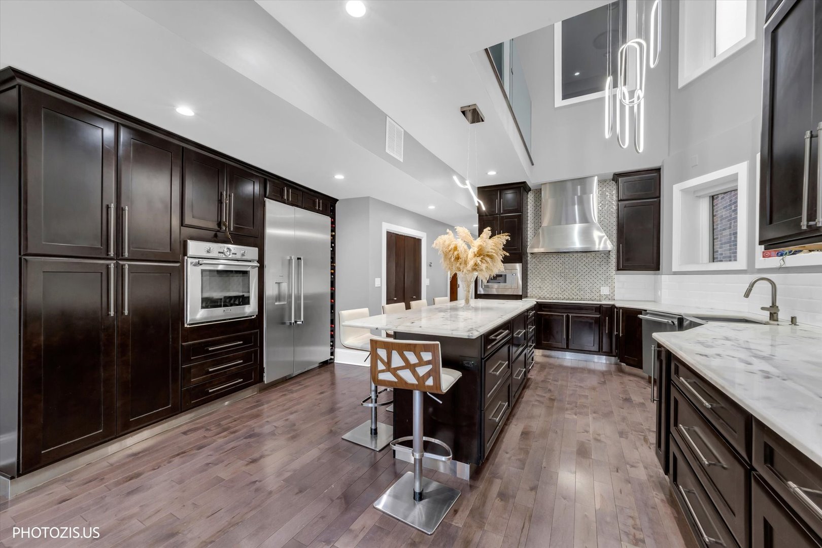 461 West Melrose Street Chicago, IL 60657 - Photo 25 of 83 a kitchen with stainless steel appliances granite countertop a kitchen island hardwood floor sink stove and granite counter top