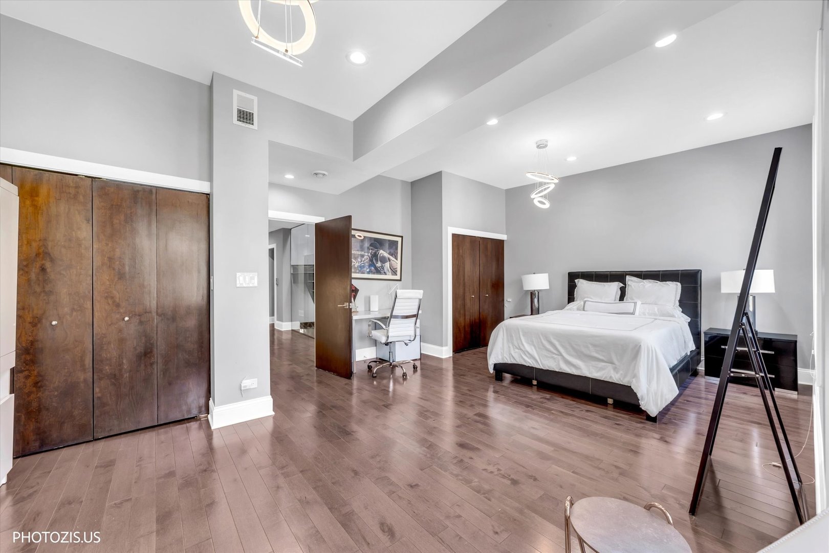 461 West Melrose Street Chicago, IL 60657 - Photo 41 of 83 a spacious bedroom with a bed and a walk in closet