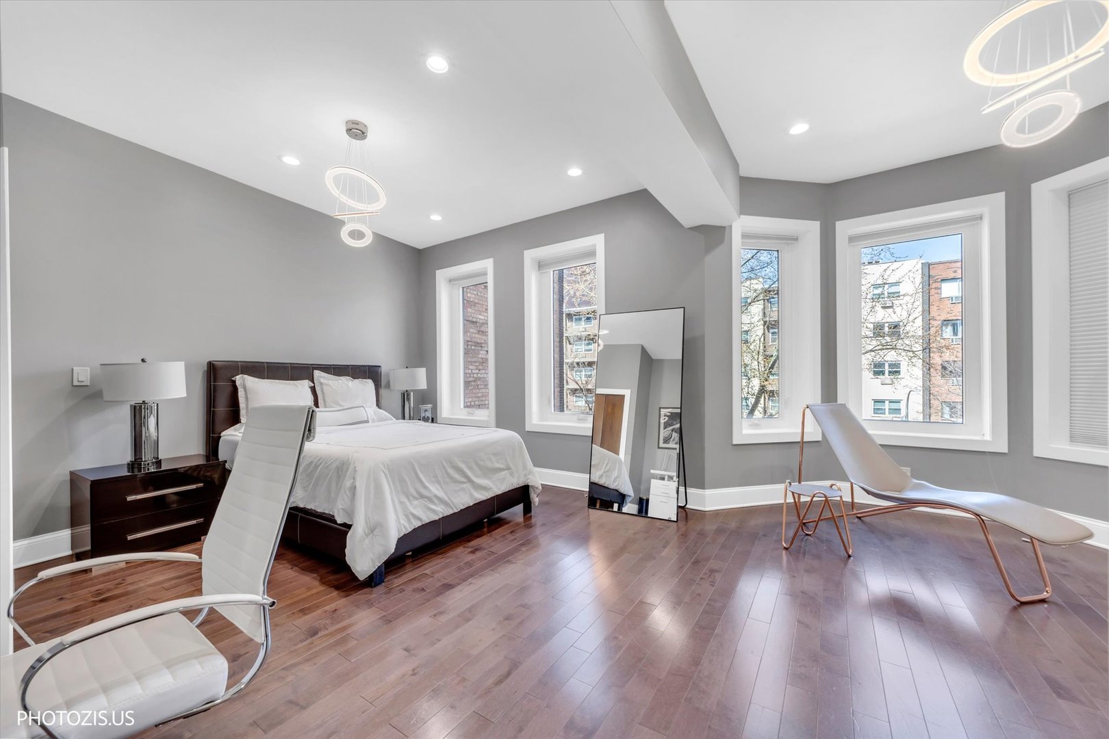 461 West Melrose Street Chicago, IL 60657 - Photo 42 of 83 a spacious bedroom with a bed and wooden floor