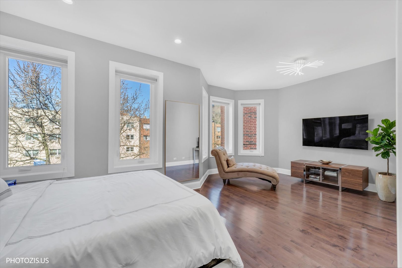 461 West Melrose Street Chicago, IL 60657 - Photo 44 of 83 a spacious bedroom with a bed and a flat screen tv