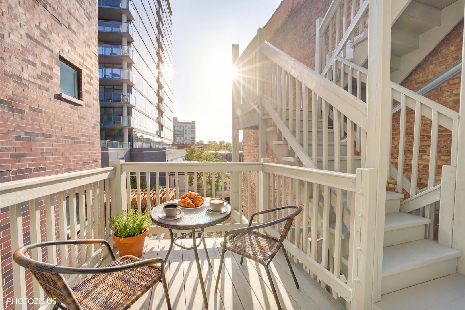 461 West Melrose Street Chicago, IL 60657 - Photo 61 of 83 a view of a balcony with chairs and a potted plant