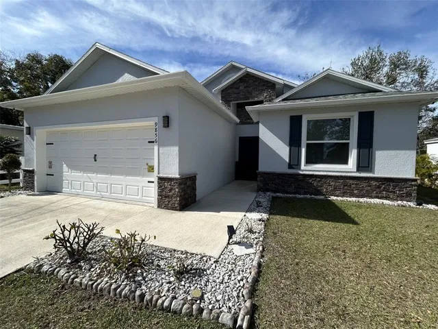 a front view of a house with garden