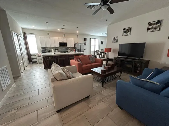 a living room with furniture and a flat screen tv