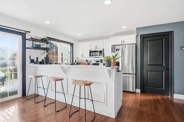 a kitchen with stainless steel appliances kitchen island a refrigerator and a stove top oven