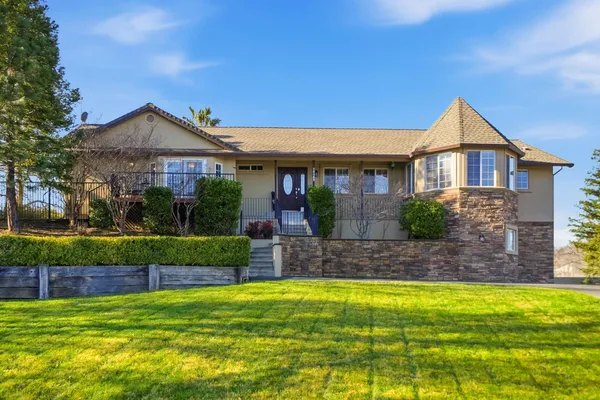 a view of house that has a yard