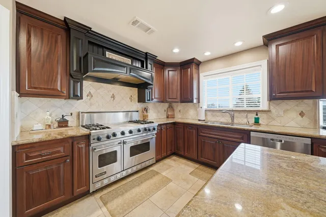 a dining room with furniture a chandelier and window