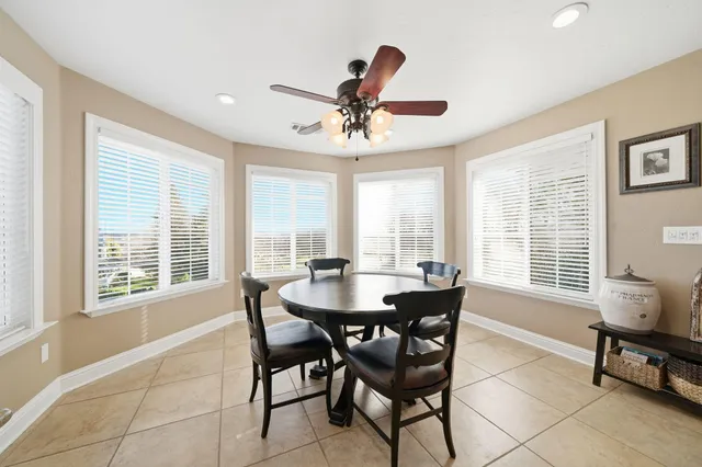 a spacious bedroom with a bed and a chandelier