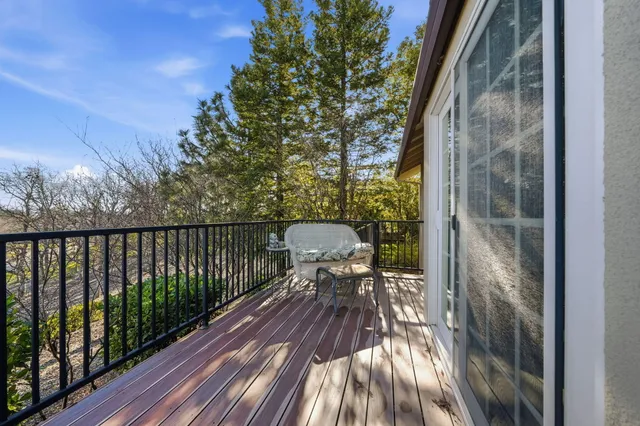 a view of balcony with wooden floor and fence