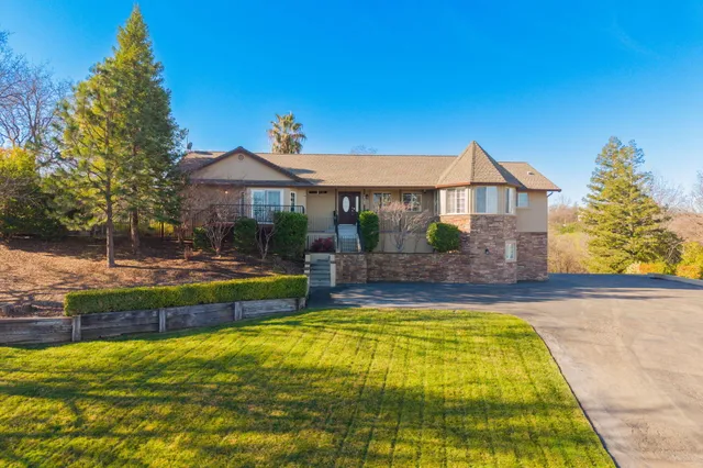 a view of a house with swimming pool and a yard
