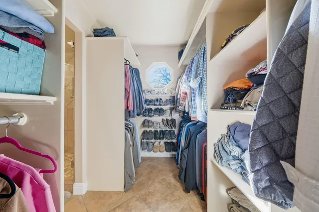 a bedroom with a bed and a mirror