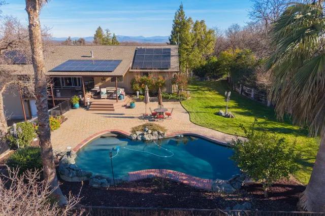 a view of a house with backyard porch and sitting area