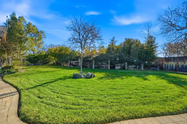 a view of a patio with couches dining table and chairs with wooden floor