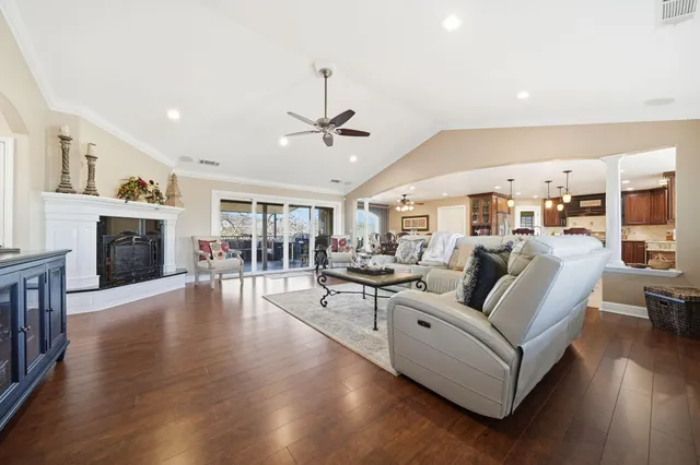 a living room with furniture wooden floor and a fireplace