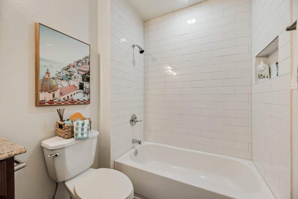 190 Merlin Way Euless, TX 76039 - Photo 22 of 39 Upstairs full bathroom #1. 2026 new shower surround completed with white subway tile to the ceiling and updated fixture