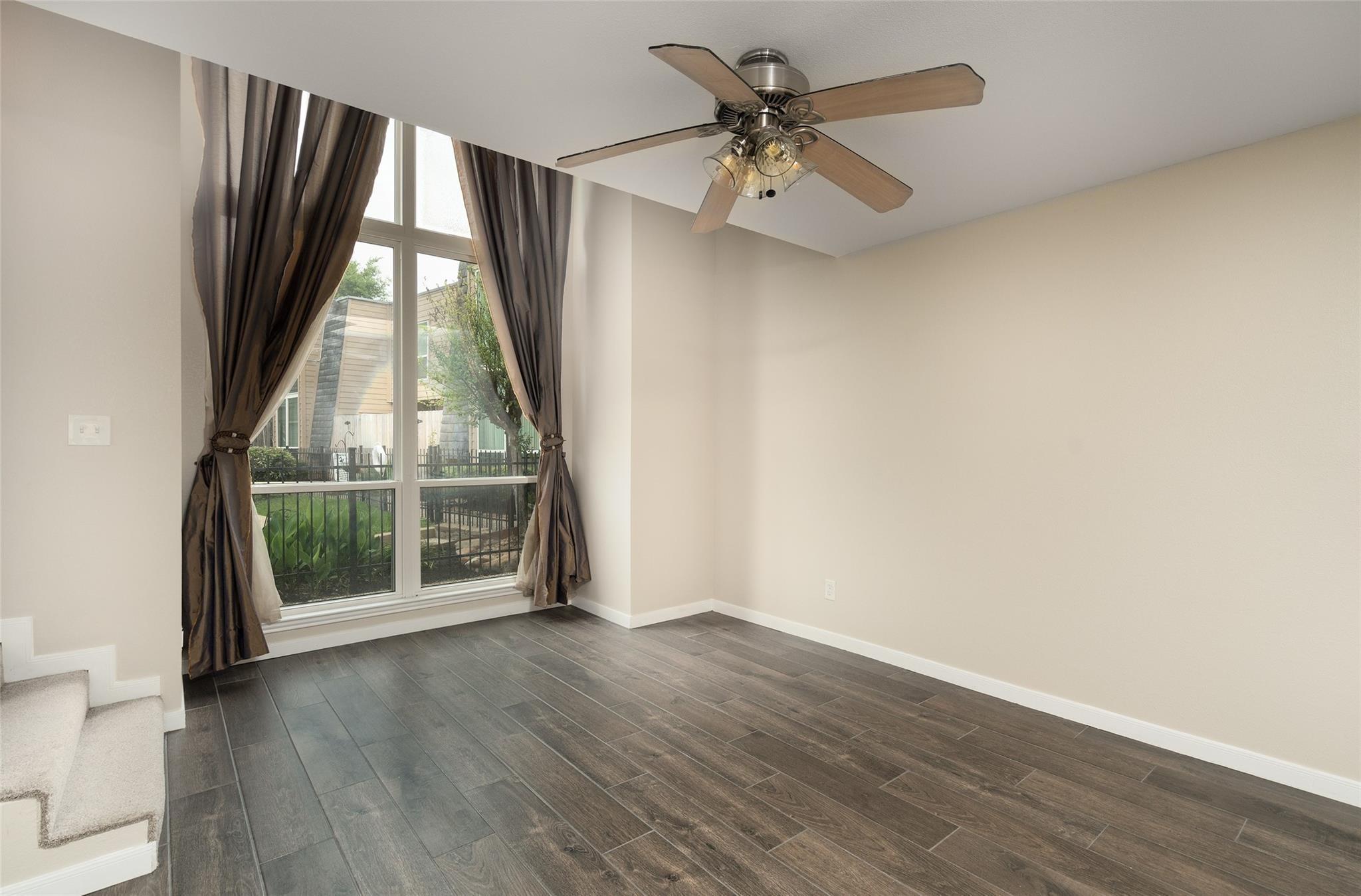 16120 Stuebner Airline Road, Unit 501 Spring, TX 77379 - Photo 14 of 23 an empty room with wooden floor fan and windows