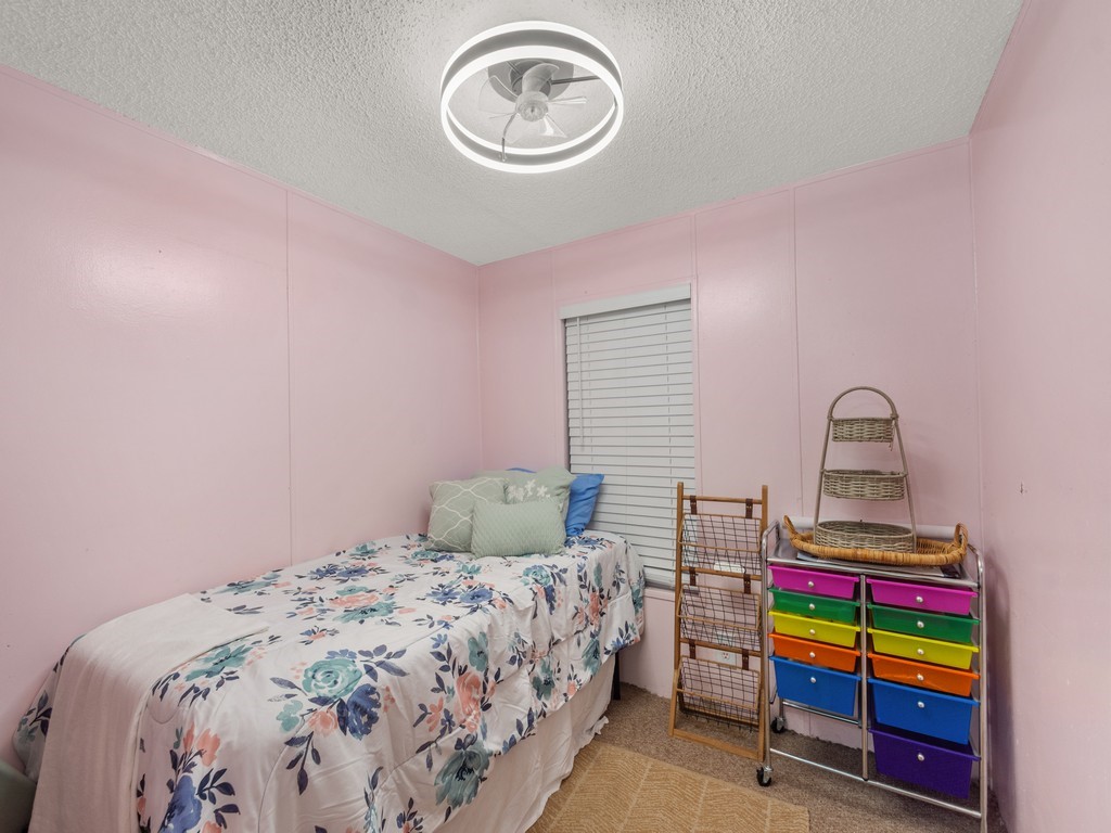 7380 129th Street Sebastian, FL 32958 - Photo 26 of 36 a bedroom with a bed and a wooden floor