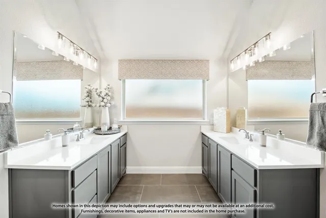 a spacious bathroom with a double vanity sink a mirror and a shower