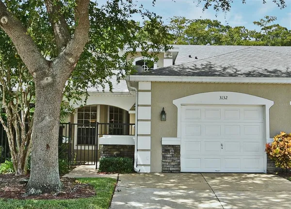 a front view of a house with a garden