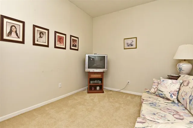 a bedroom with a bed and a lamp on dresser