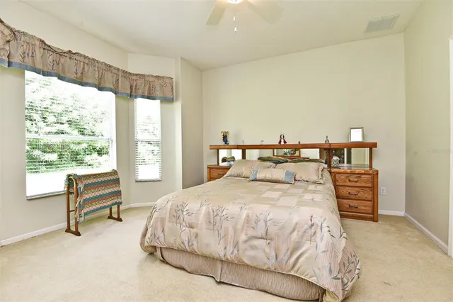 a bedroom with a bed and a large window