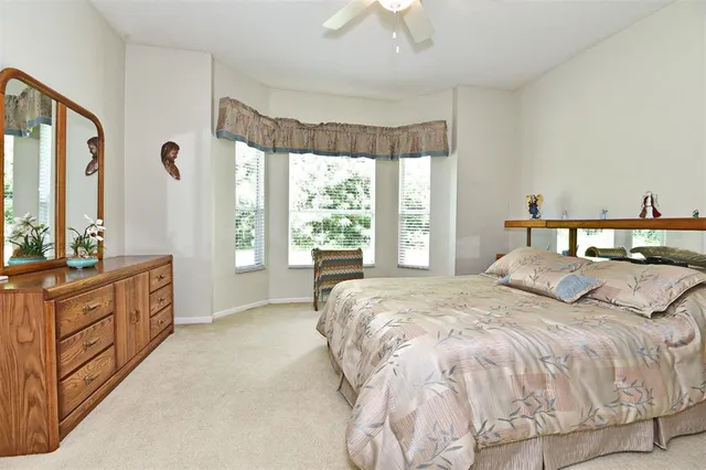 a bedroom with a large bed and a large window